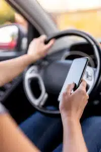 Woman driving a car and using a phone