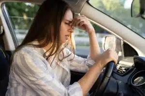 Tired woman driving a car